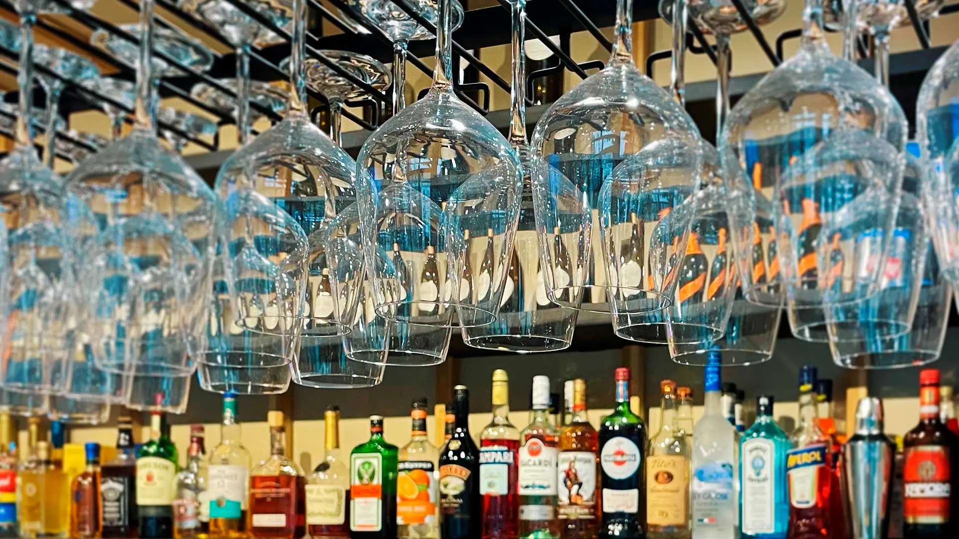 Wine glasses and bottles behind the bar at Café Korzo